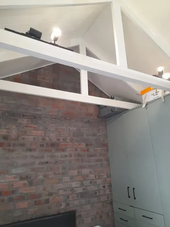Exposed roof trusses and ceiling work by our building team