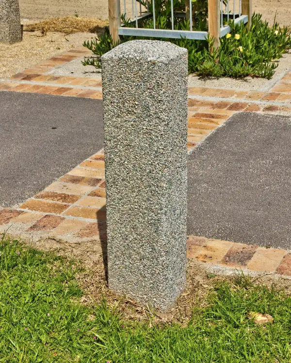 Quartet precast concrete bollard with chamfered corners and an exposed aggregate finish