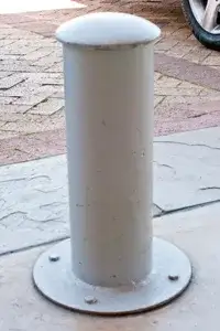 Low, dome-topped Quay steel bollard bolted onto a round surface baseplate