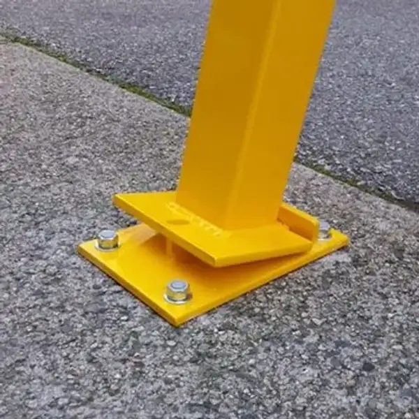 Square-section steel bollard hinged to a bolt-down flat base plate on a parking deck