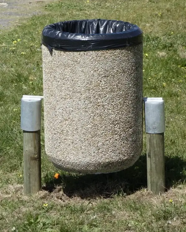 Round 500 swing concrete bin slung between two posts on galvanised brackets, with a black bag liner over the rim