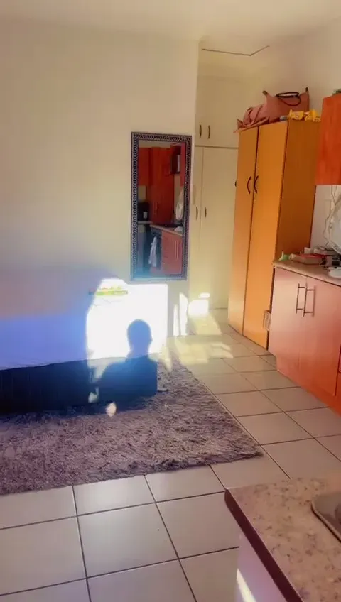 The Wynberg flat before the renovation, a cramped bedsit with orange melamine cupboards